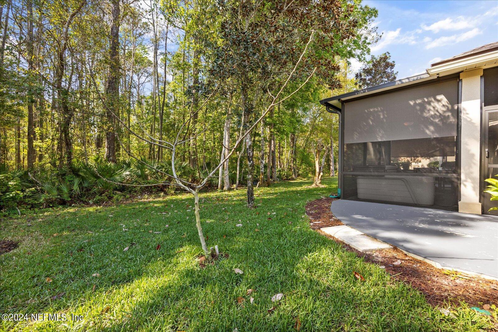 1283 Paradise Pond Road St. Augustine, FL 32092 - Photo 38 of 47 a backyard of a house with table and chairs