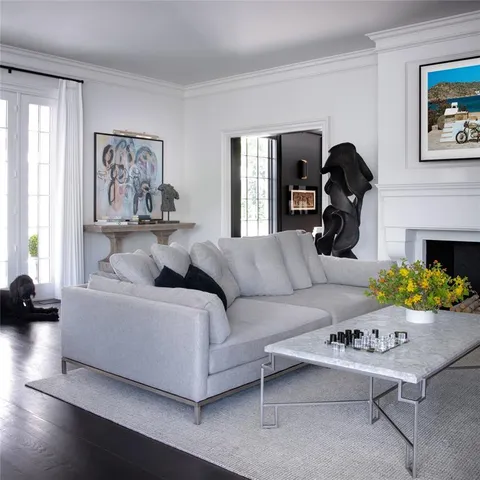 a living room with furniture and a painting on the wall