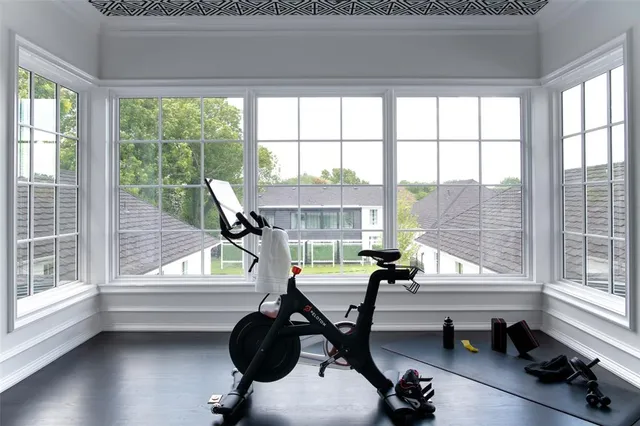 a view of a room with gym equipment and windows