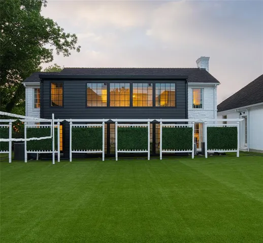 a backyard of a house with table and chairs