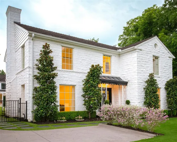 a front view of a house with garden