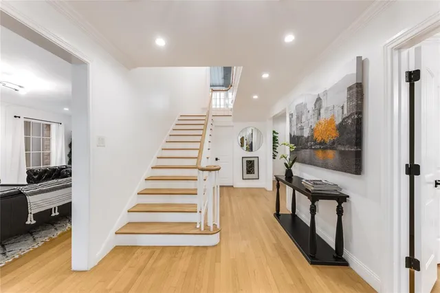 a view of entryway and hall with wooden floor