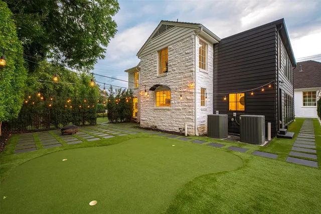 a view of a house with backyard and sitting area