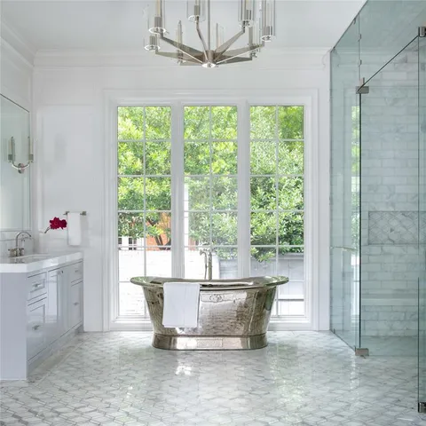 a living room with a large window and chandelier
