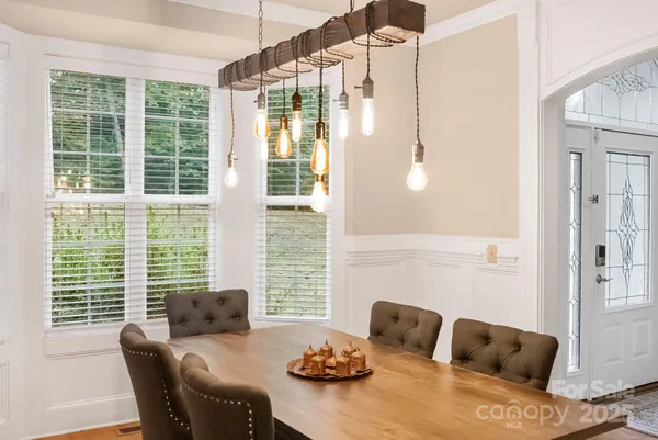 a view of a dining room with furniture and windows