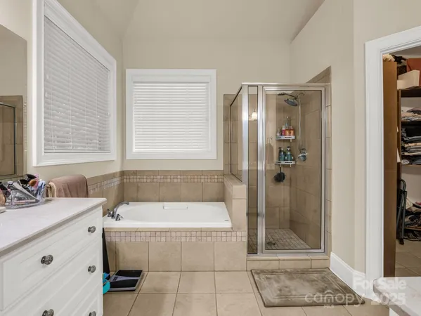 a bathroom with a tub a sink and a mirror