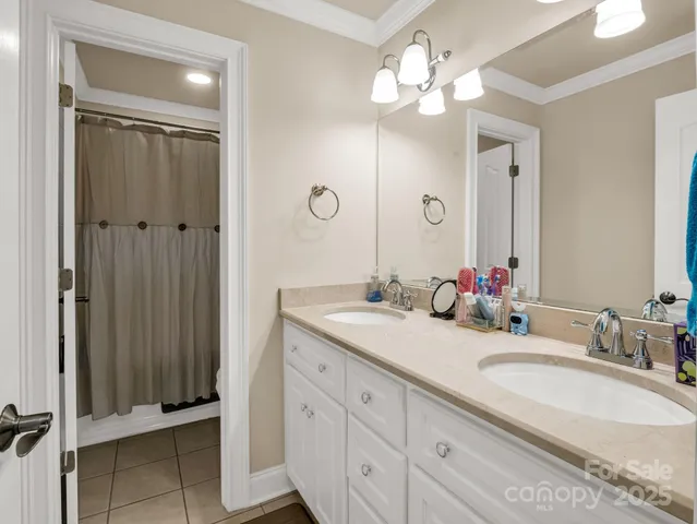 a bathroom with a double vanity sink and a mirror