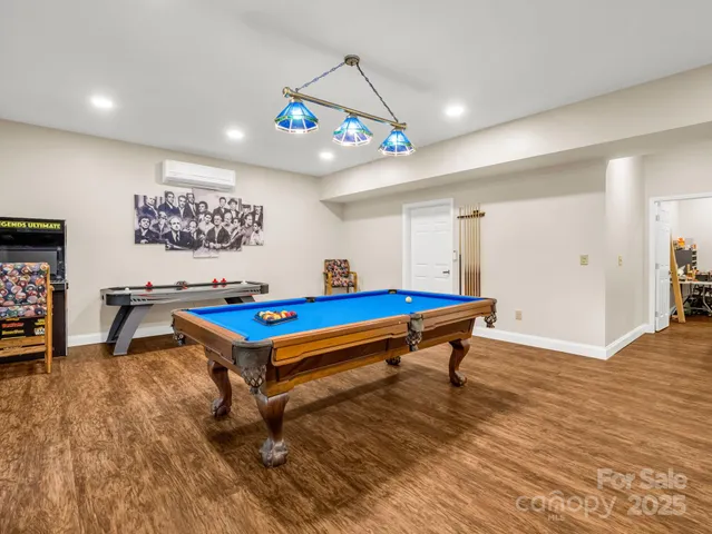 a room with pool table and windows