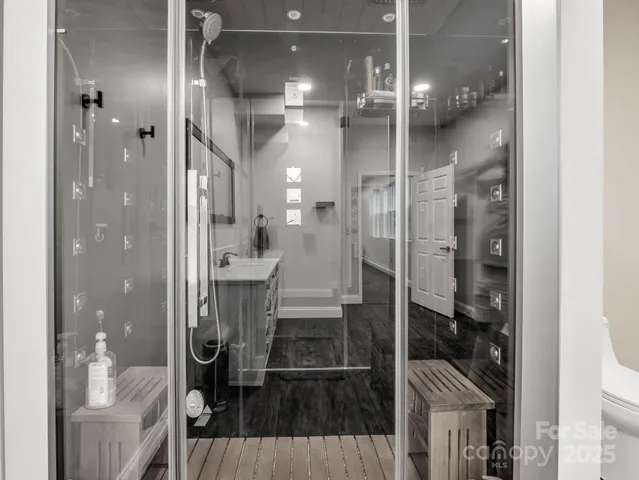 a bathroom with a glass shower door