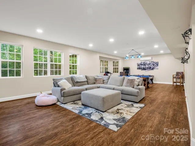 a living room with furniture potted plant and window