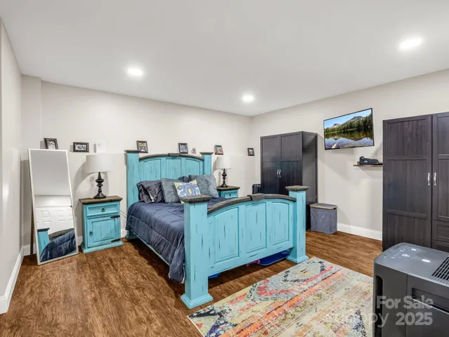 a bedroom with a bed and a mirror