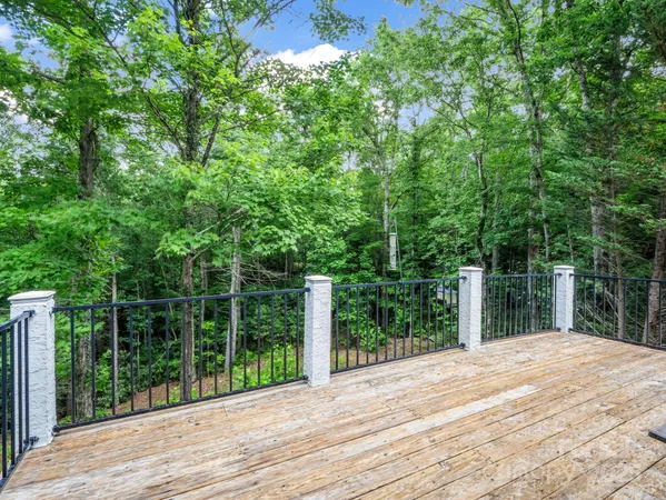 a view of a backyard with wooden floor and fence