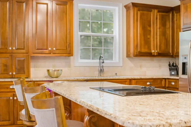 a kitchen with stainless steel appliances granite countertop a sink and a window