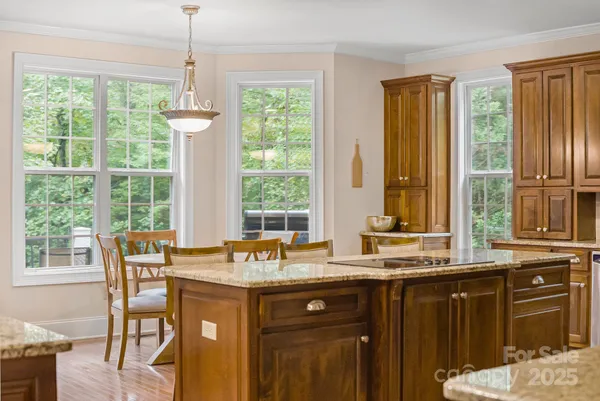 a kitchen with a window a sink and dining table