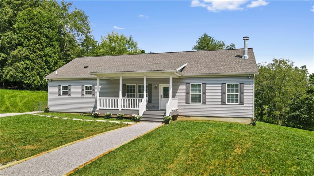 210 Shoaf Road Smithfield, PA 15478 - Photo 1 of 25 a view of a house with a yard and plants