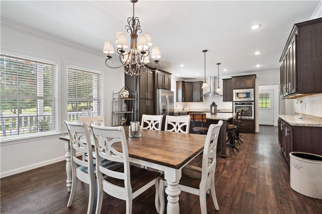 210 Shoaf Road Smithfield, PA 15478 - Photo 12 of 25 a view of a dining room with furniture a chandelier and wooden floor