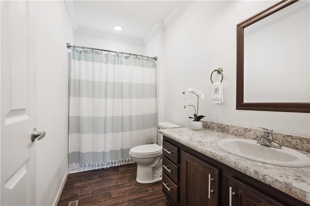 210 Shoaf Road Smithfield, PA 15478 - Photo 25 of 25 a bathroom with a granite countertop sink a toilet a mirror and shower