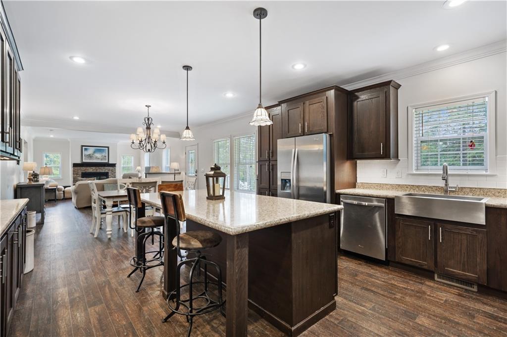 210 Shoaf Road Smithfield, PA 15478 - Photo 7 of 25 a kitchen with stainless steel appliances granite countertop a table chairs stove sink and cabinets