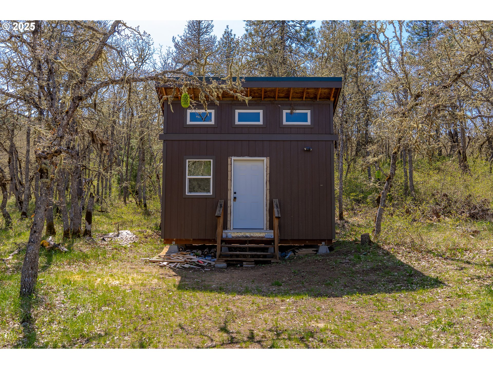 Stacker Butte Road Lyle, WA 98635 - Photo 3 of 30 a view of a small house with yard and trees in the background