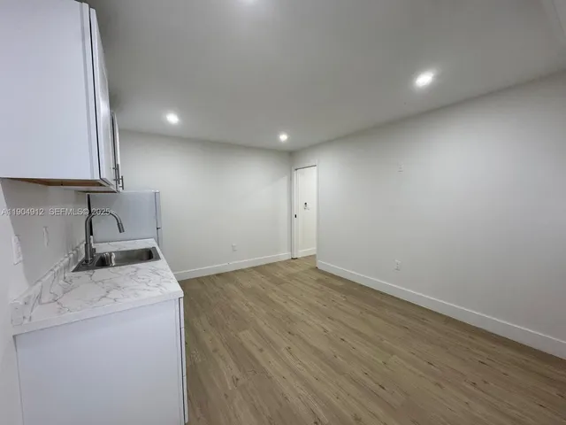 a view of storage and utility room with a sink dryer and washer