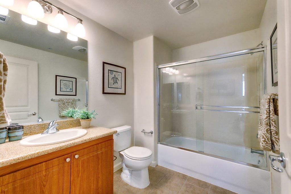 1883 Agnew Road, Unit 329 Santa Clara, CA 95054 - Photo 23 of 46 a bathroom with a granite countertop sink toilet and shower