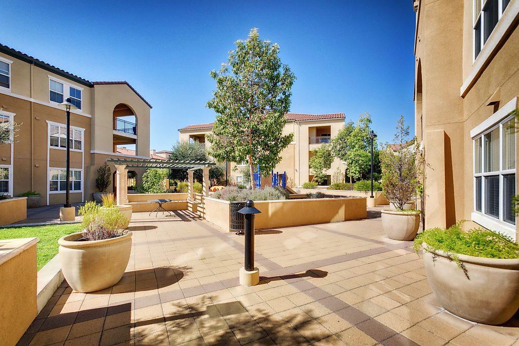 1883 Agnew Road, Unit 329 Santa Clara, CA 95054 - Photo 33 of 46 a view of a patio with couches table and chairs and potted plants