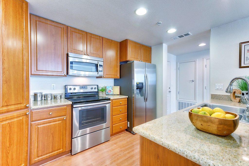 1883 Agnew Road, Unit 329 Santa Clara, CA 95054 - Photo 8 of 46 a kitchen with stainless steel appliances granite countertop a stove a refrigerator and a refrigerator