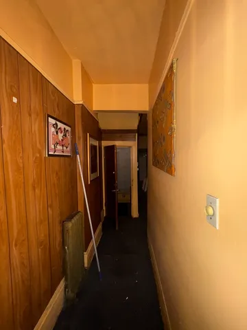 a view of a hallway with entryway door