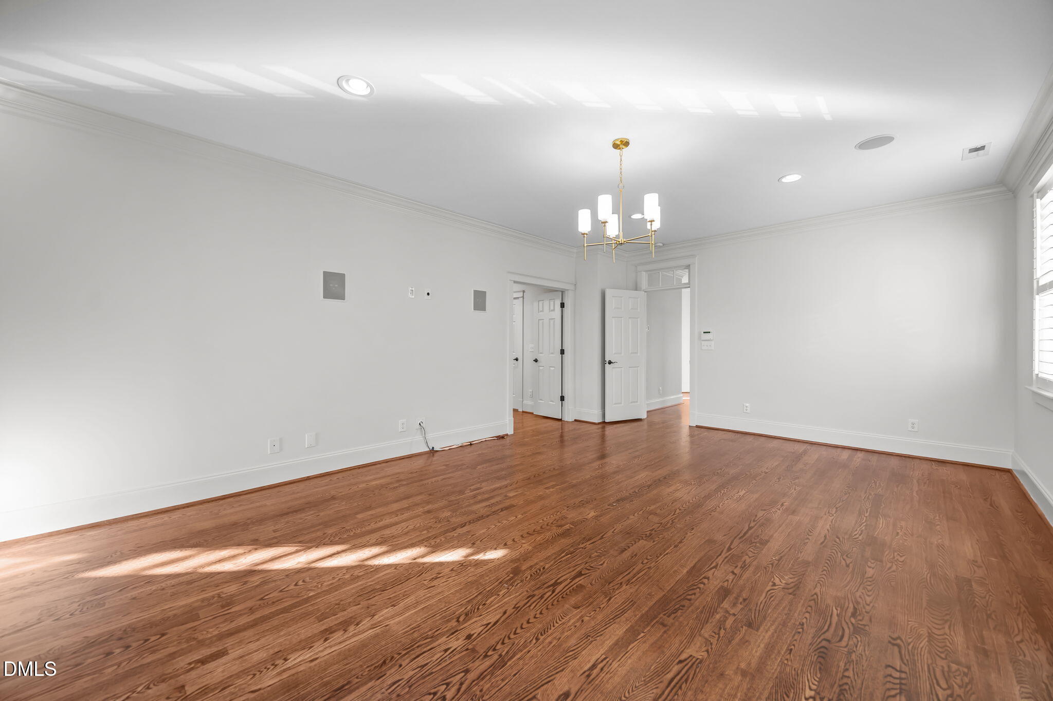1705 Carson Street Raleigh, NC 27608 - Photo 22 of 47 an empty room with wooden floor and chandelier fan