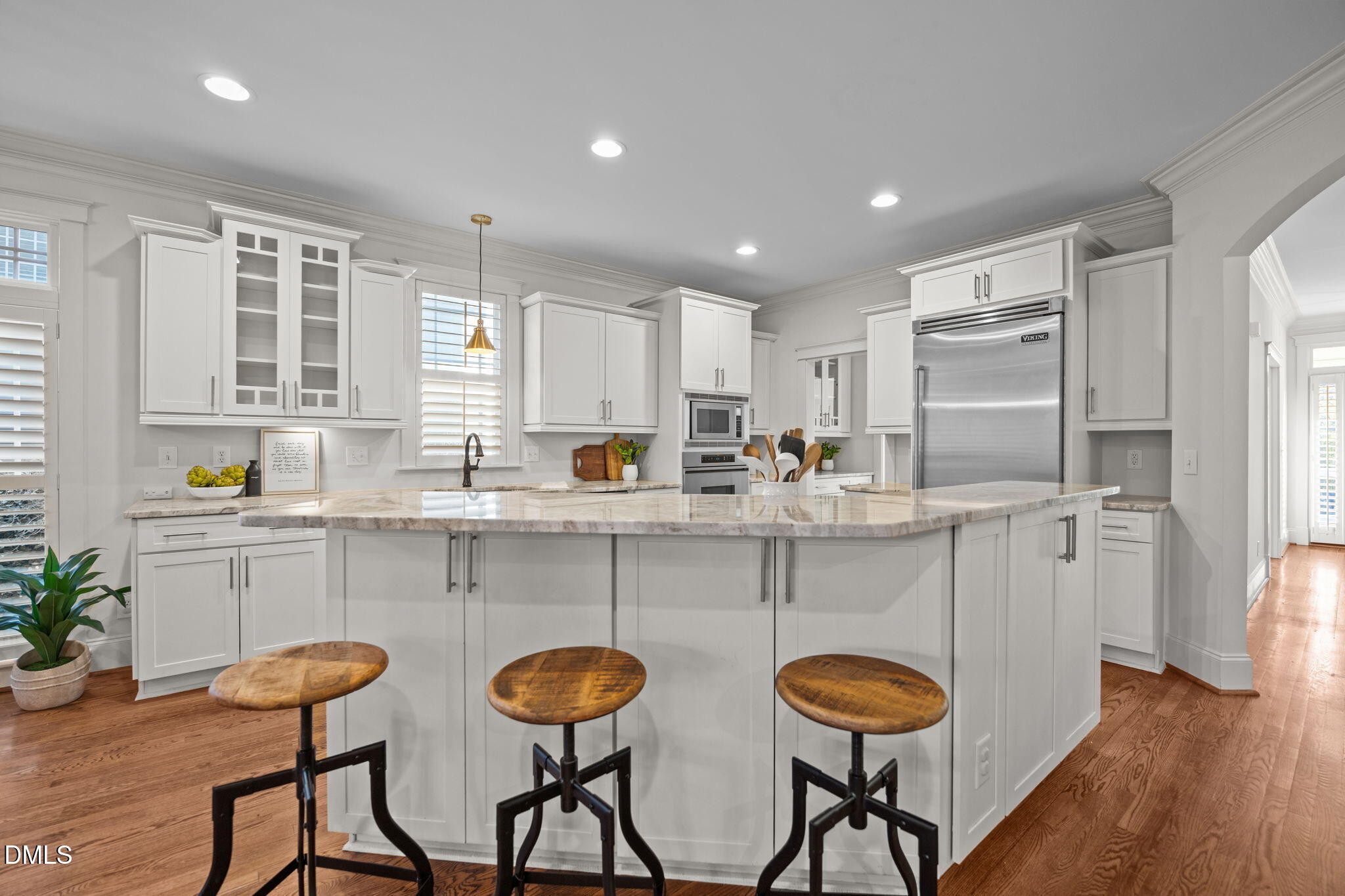 1705 Carson Street Raleigh, NC 27608 - Photo 8 of 47 a kitchen with stainless steel appliances a dining table chairs sink and cabinets