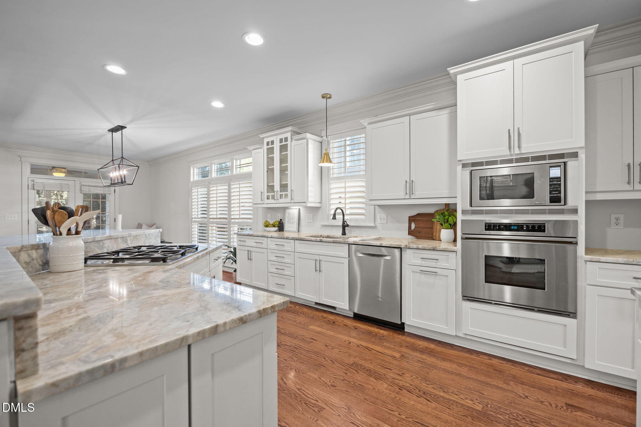 1705 Carson Street Raleigh, NC 27608 - Photo 10 of 47 a kitchen with stainless steel appliances kitchen island granite countertop a stove a sink and white cabinets