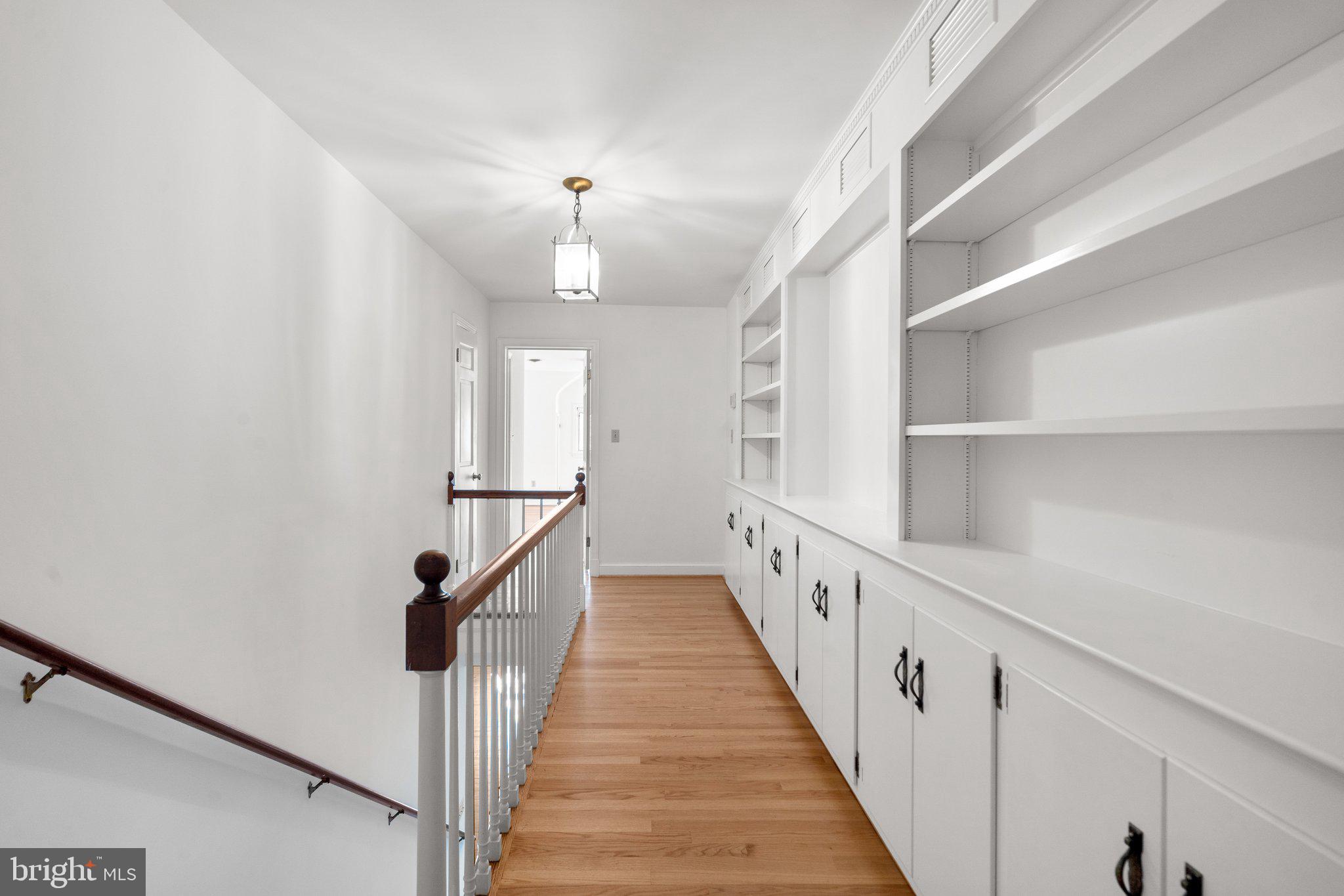25915 Woodfield Road Damascus, MD 20872 - Photo 29 of 61 Upstairs Hallway with built in bookkshelves