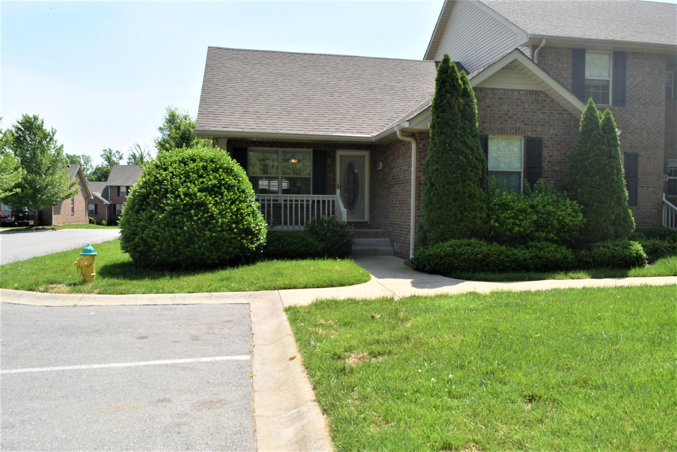 135 Excell Road, Unit 301 Clarksville, TN 37043 - Photo 1 of 5 a front view of a house with garden