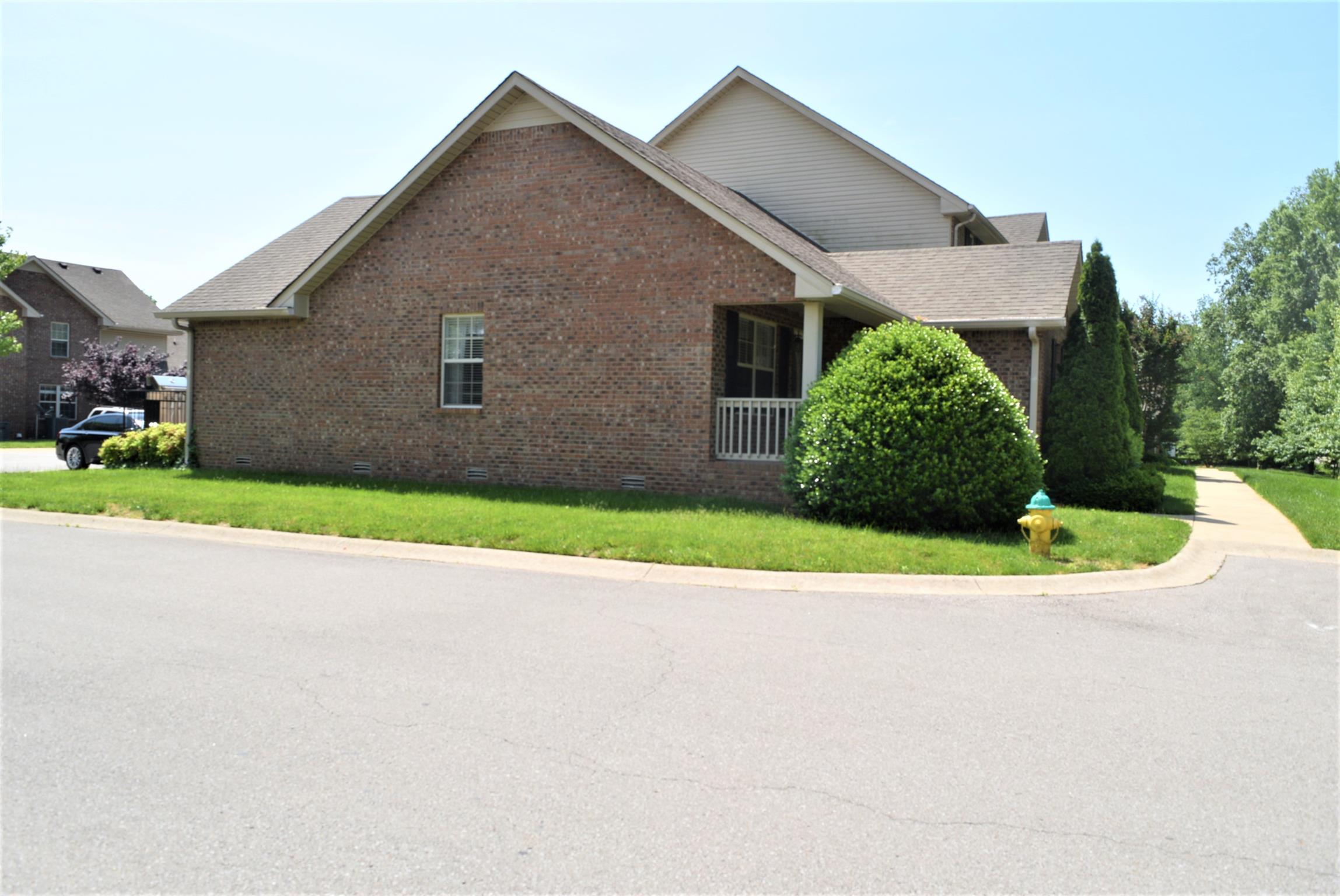 135 Excell Road, Unit 301 Clarksville, TN 37043 - Photo 4 of 5 a view of a house with a yard and garage