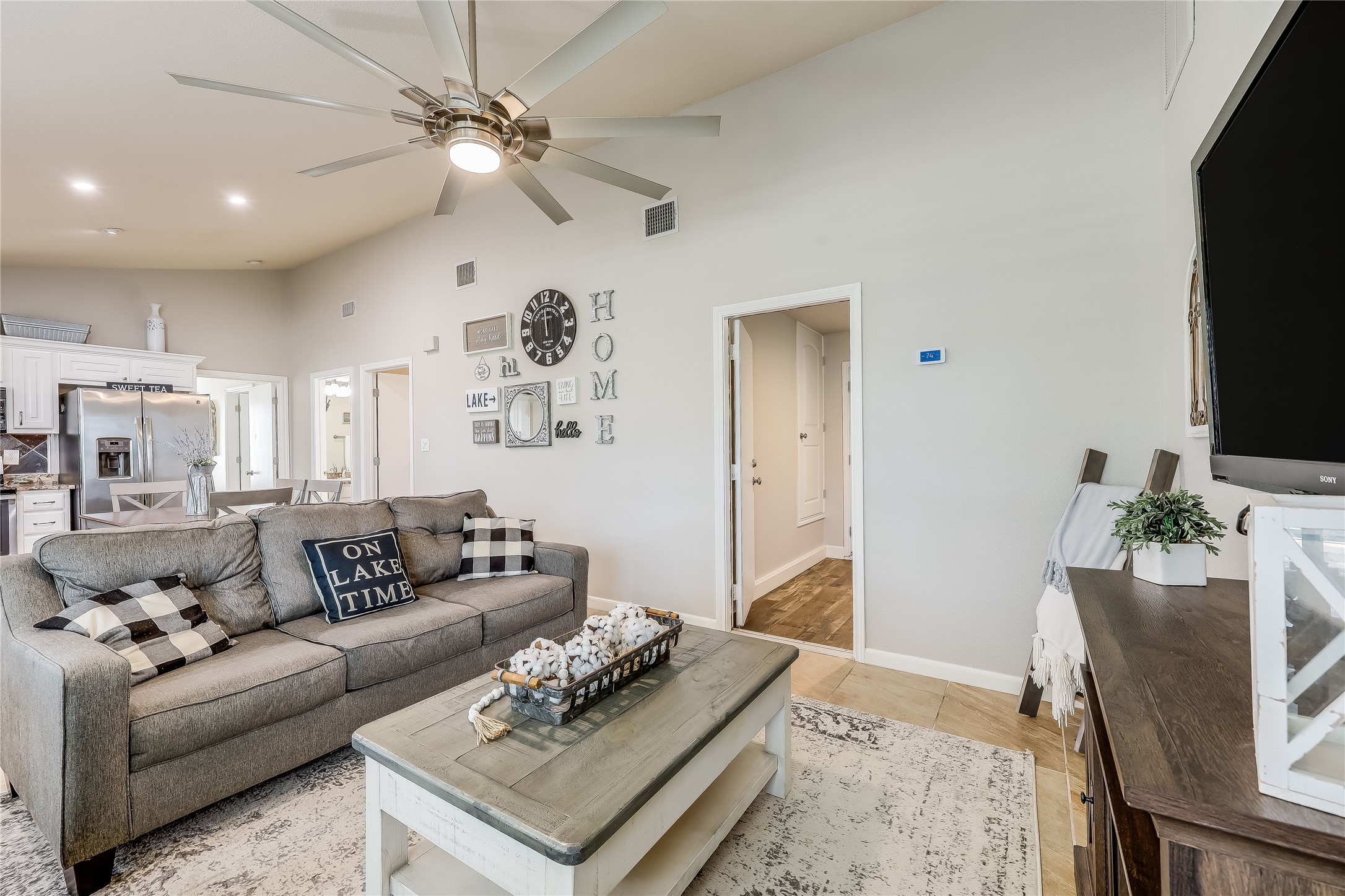 426 Summit Ridge Drive North Point Venture, TX 78645 - Photo 7 of 28 Tiled living room featuring high vaulted ceiling and ceiling fan
