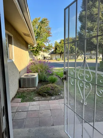 a view of a door and chair in the patio