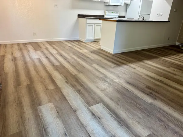 a view of a room with wooden floor