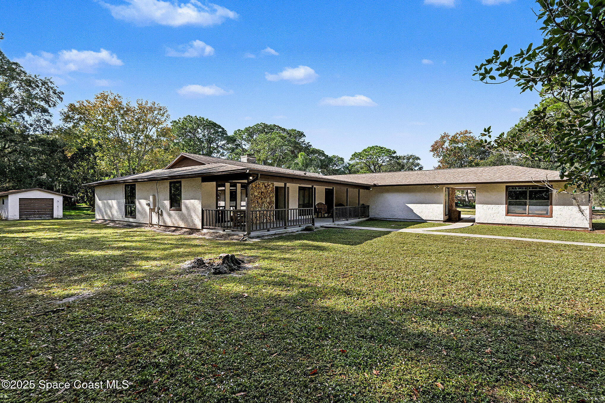 a front view of house with yard entertaining space and seating area