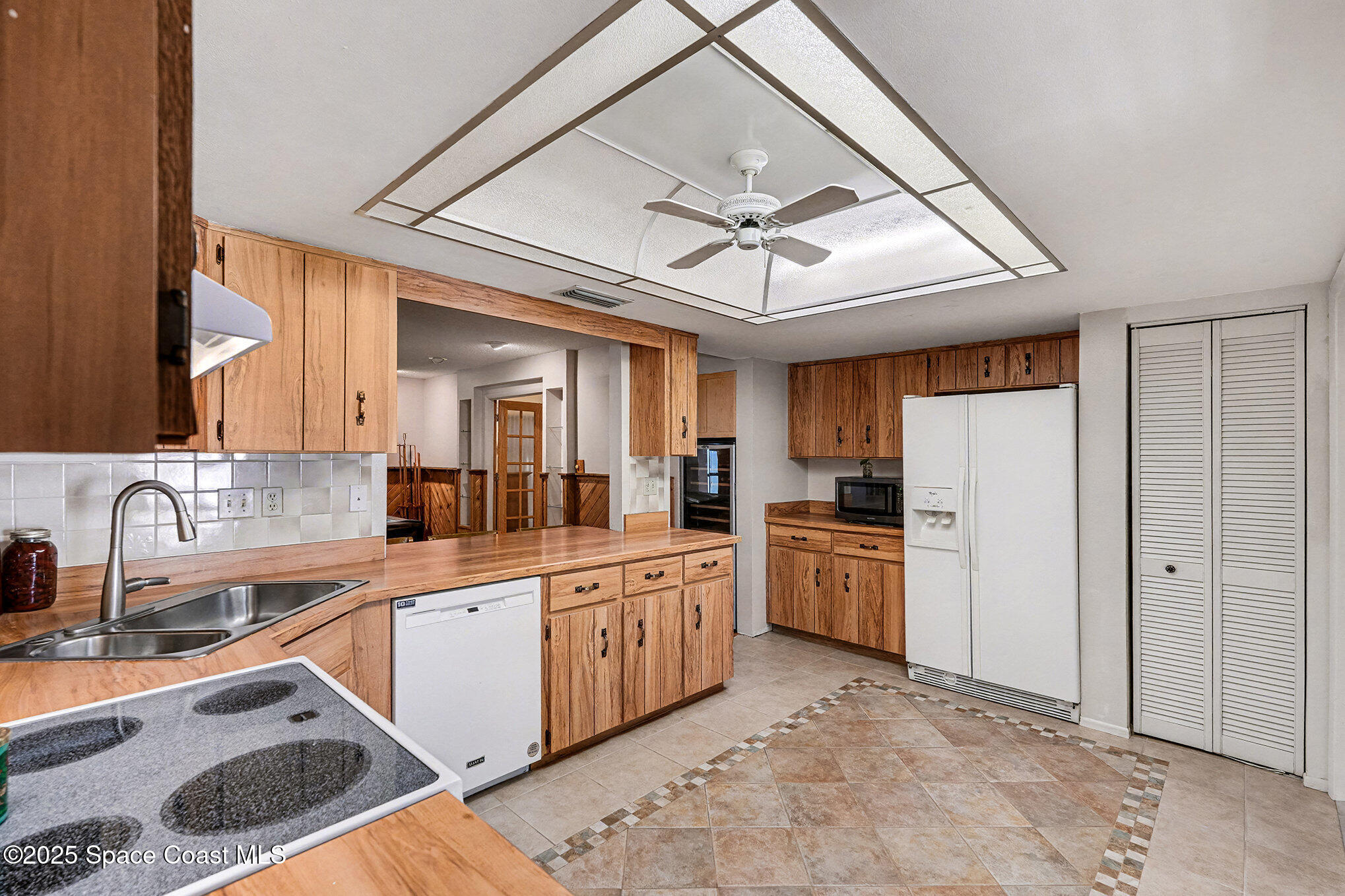 265 Mockingbird Lane Merritt Island, FL 32953 - Photo 11 of 34 a kitchen with a sink cabinets and stainless steel appliances