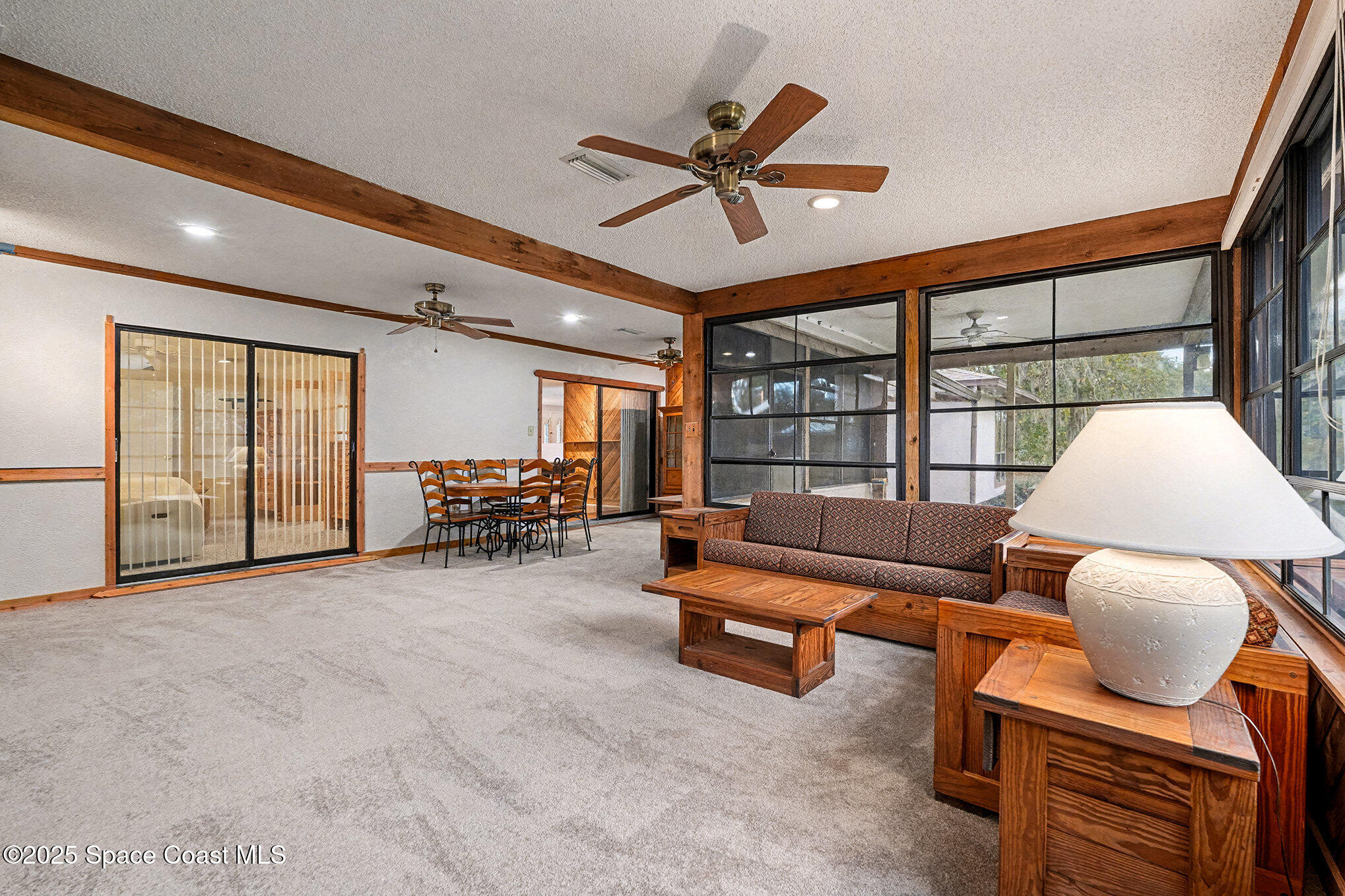 265 Mockingbird Lane Merritt Island, FL 32953 - Photo 13 of 34 a living room with furniture and a large window