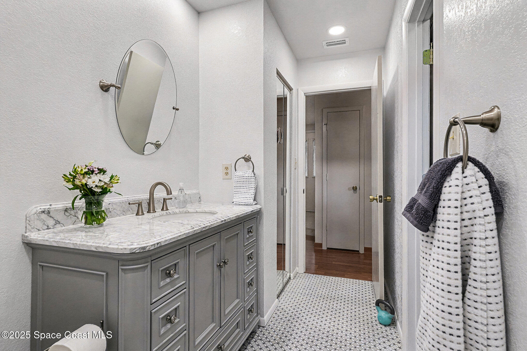 265 Mockingbird Lane Merritt Island, FL 32953 - Photo 15 of 34 a en suite bathroom with a granite countertop sink and a mirror