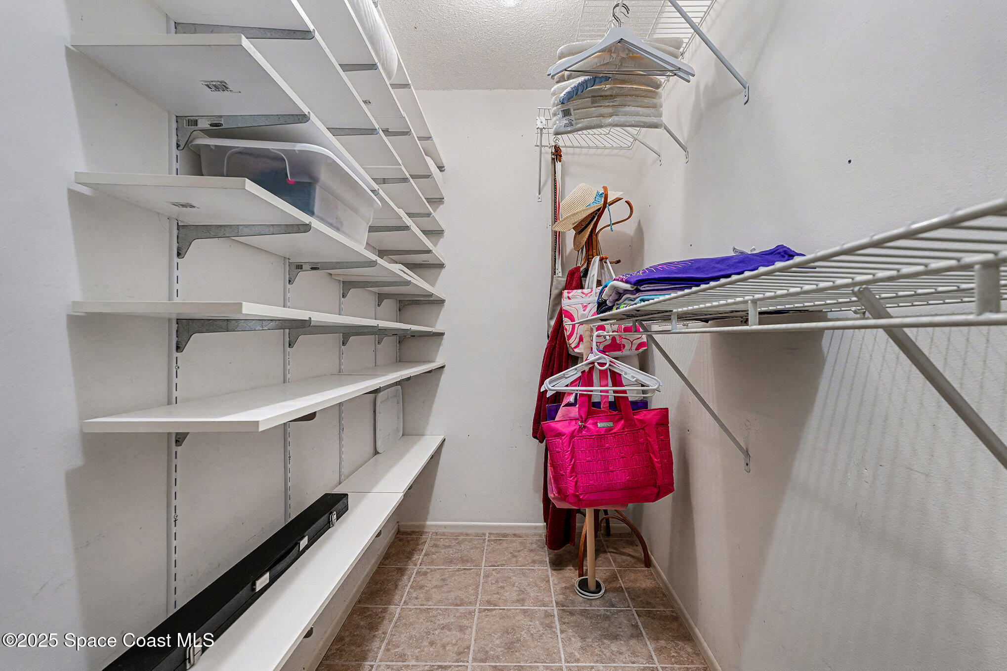 265 Mockingbird Lane Merritt Island, FL 32953 - Photo 17 of 34 a view of walk in closet with clothes and shoes