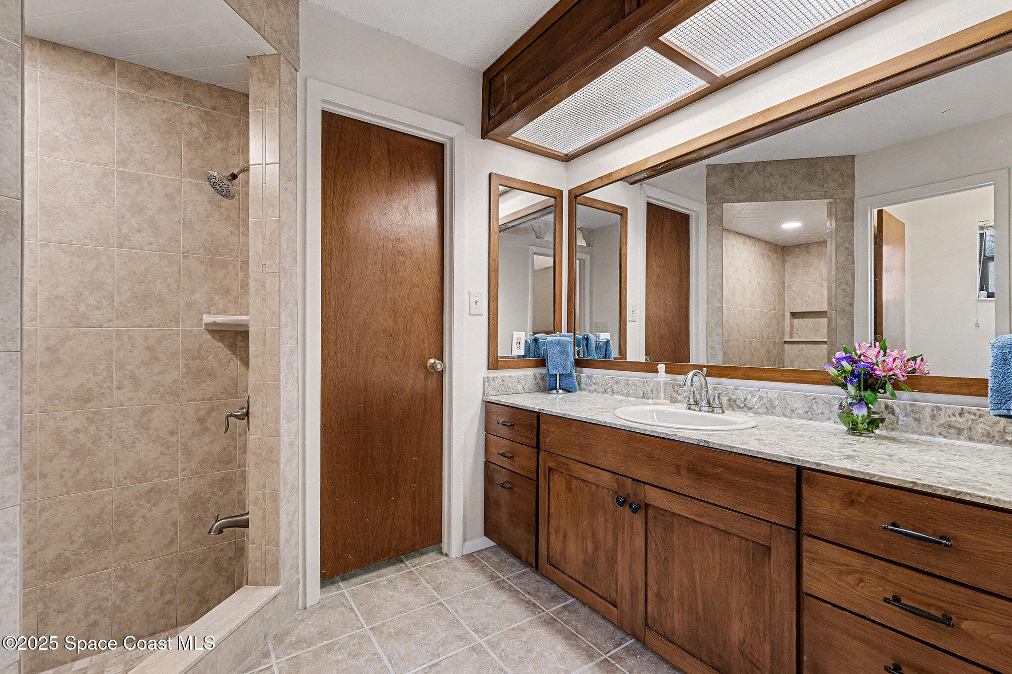 265 Mockingbird Lane Merritt Island, FL 32953 - Photo 4 of 34 a bathroom with a double vanity sink and a mirror