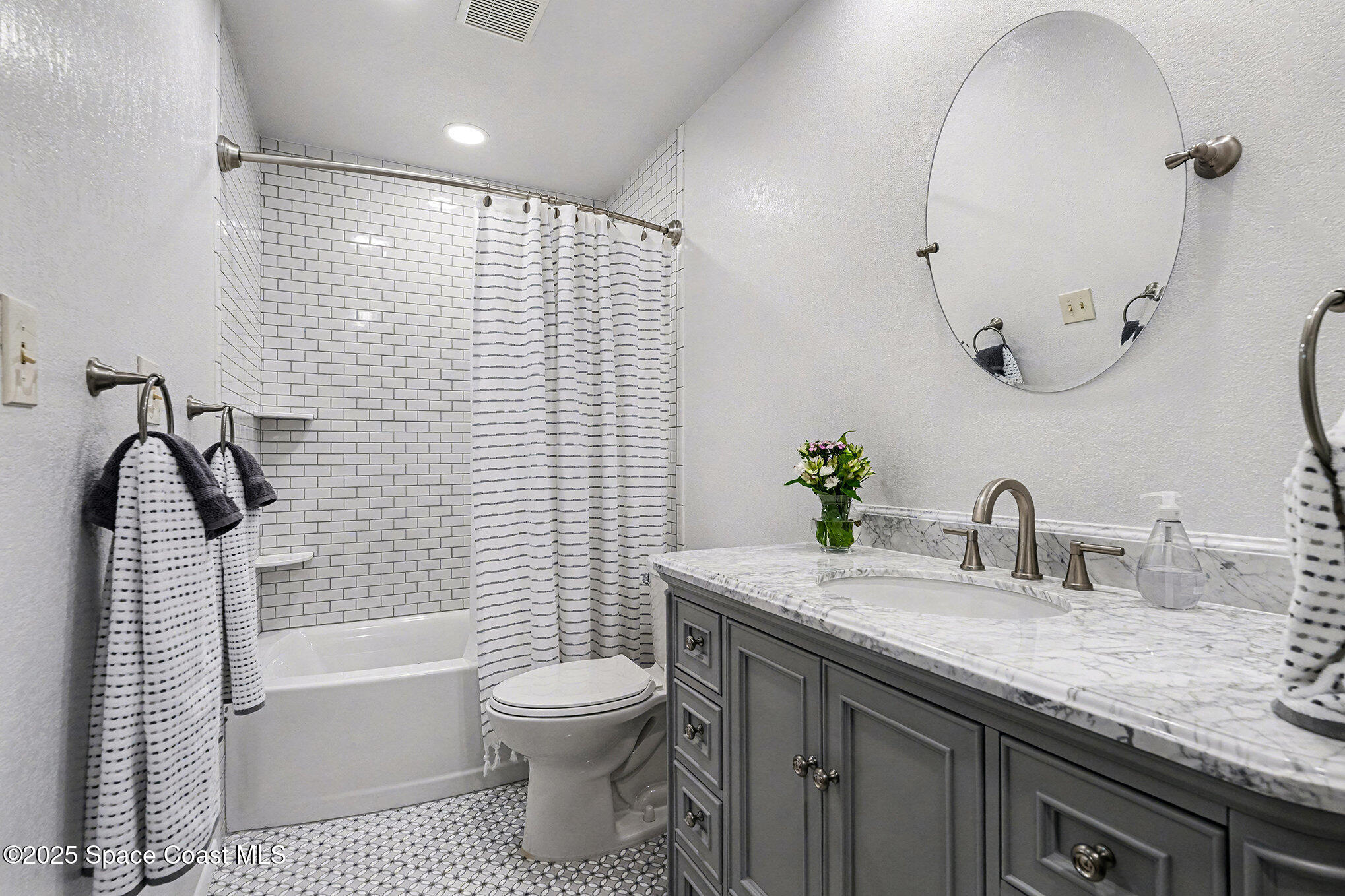 265 Mockingbird Lane Merritt Island, FL 32953 - Photo 6 of 34 a bathroom with a sink a toilet and a bathtub