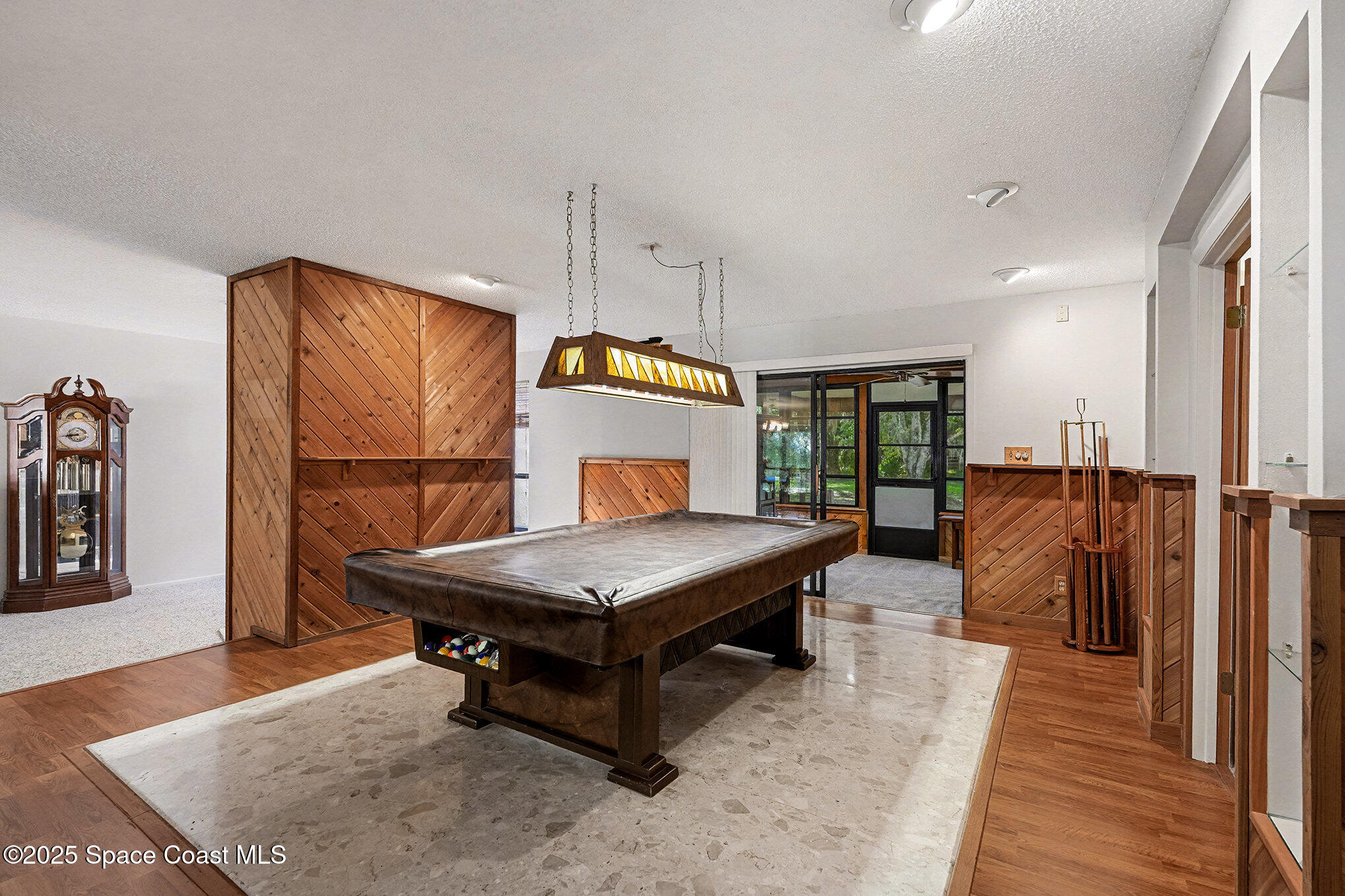 265 Mockingbird Lane Merritt Island, FL 32953 - Photo 10 of 34 a living room with furniture a table and wooden floor
