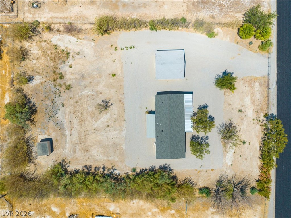 4081 Retread Road Pahrump, NV 89048 - Photo 88 of 98 An aerial perspective showcases a home with ample undeveloped land and a separate utility building.