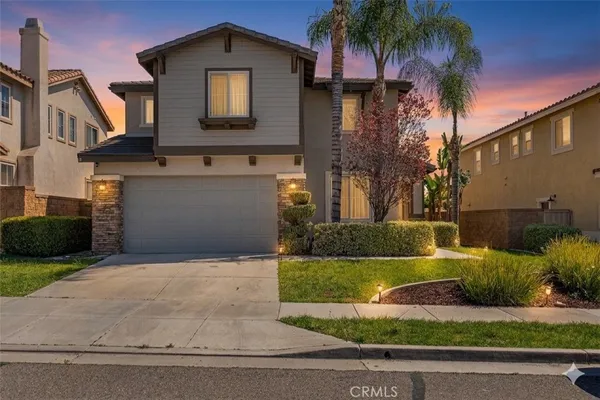 a front view of a house with a yard garage and outdoor seating