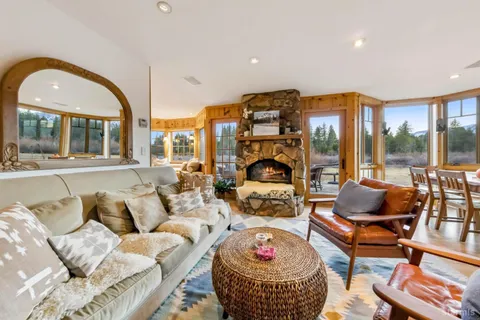 a living room with furniture and a floor to ceiling window