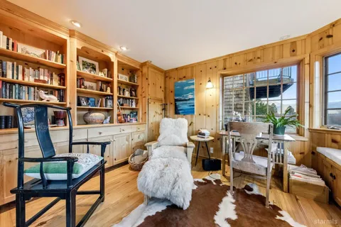 a living room with furniture and a book shelf