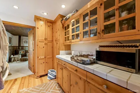 a kitchen with stainless steel appliances granite countertop a stove and a wooden floors